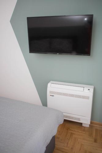 a flat screen tv hanging on a white wall at Apartment Dream Trebinje in Trebinje