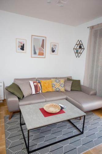 a living room with a couch and a coffee table at Apartment Dream Trebinje in Trebinje