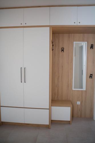 a room with a large white cabinet and a mirror at Apartment Dream Trebinje in Trebinje
