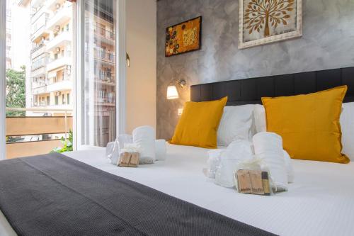 a bedroom with a bed with two boxes on it at Luxury Boutique Hotel in Rome