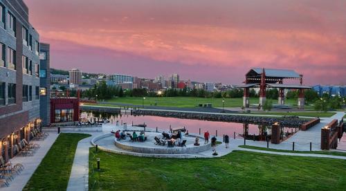a group of people standing around a fountain outside a building at Pier B Resort in Duluth