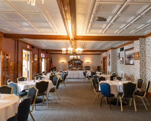 a dining room with white tables and chairs at Winthrop Arms Hotel Restaurant Logan Airport in Winthrop