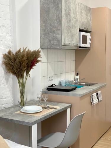 a kitchen with a table with a plate and a chair at Апартаменти MYFREEDOM поруч із метро Лук'янівська in Kyiv