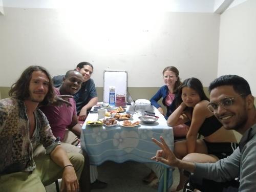 a group of people sitting around a table at david hostel in Aswan