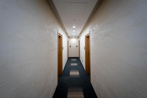 a corridor of a hallway with two doors at CentRoom Gold in Zlatibor