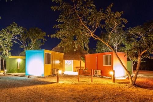 a row of tiny homes at night at Xuux Peek by Tecnohotel in Yaxché