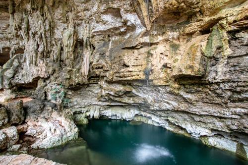 a cave with a pool of water in it at Xuux Peek by Tecnohotel in Yaxché