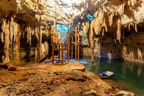 a room in a cave with a pool of water at Xuux Peek by Tecnohotel in Yaxché