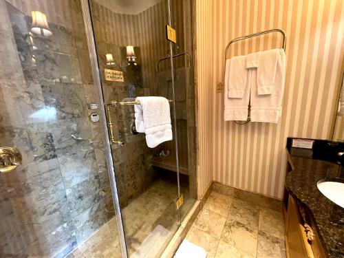 a bathroom with a shower and a sink at Celebrity Boutique Hotel in Deadwood