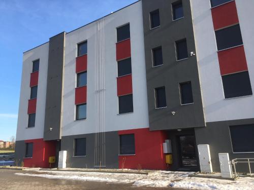 a large building with red and white at Apartament Fibra Grande in Rybnik