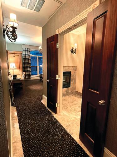 a hallway with a room with a fireplace and a door at Celebrity Boutique Hotel in Deadwood
