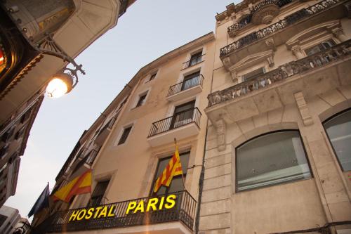 a building with a sign for the hostel paris at Hostal Paris in Barcelona