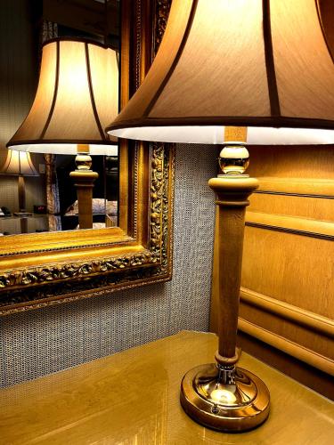 a lamp sitting on a table in front of a mirror at Celebrity Boutique Hotel in Deadwood