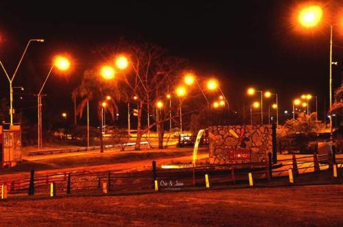 a parking lot with street lights at night at SUEÑOS DE TERMAS in Chajarí