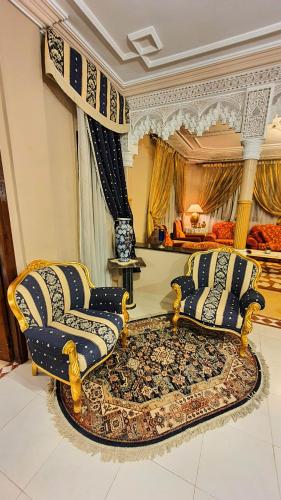 a living room with two chairs and a rug at Oranger Family House Marrakech City Center, Private Large House, Terasse Garden View, Free Parking in Marrakech