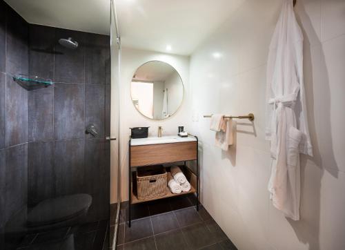 a bathroom with a sink, toilet and shower stall at Mantra Terrace Hotel in Brisbane
