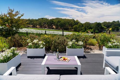 a table with a bowl of fruit and a bottle of wine at Esto house in Crafers