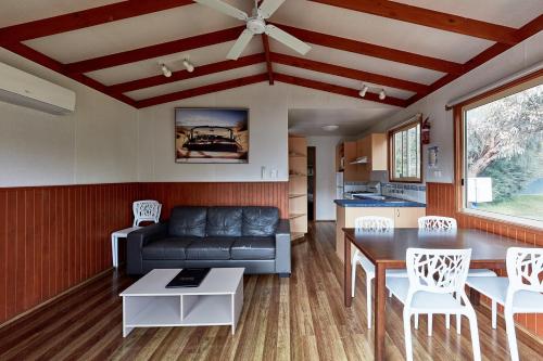 a living room with a couch and a table at Marengo Family Caravan Park in Marengo