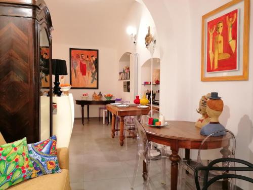 a living room with tables and chairs in a room at La Foresteria Garden Boutique B&B in Catania