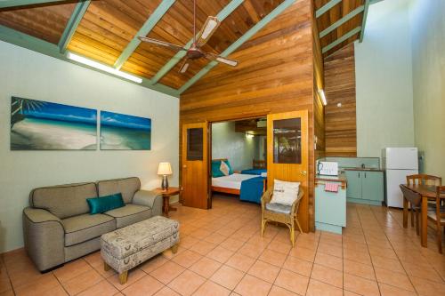 sala de estar con sofá y dormitorio en Beachside Cottage - A Private Peaceful Hidden Gem 50m to Beach en Nelly Bay