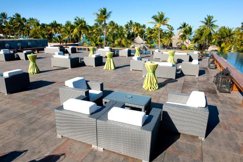 a resort with tables and chairs and a pool at Barceló Bávaro Beach - Adults Only All Inclusive in Punta Cana