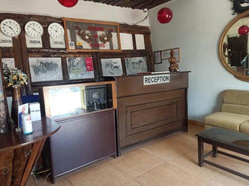 a reception room with a reception desk and clocks on the wall at Dragon I Resorts in McLeod Ganj