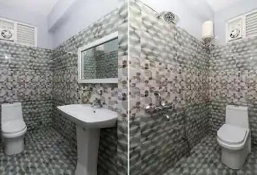 a bathroom with a sink and a toilet and a shower at Jubilee Homes in Hyderabad