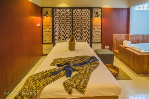 a room with a bed with bow ties on it at Avoca Inn in Hulhumale