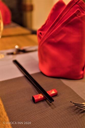 two chopsticks and a red bag on a table at Avoca Inn in Hulhumale