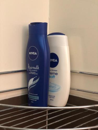 two bottles of sunscreen and aitatingitatingitatingitatingitatingitatingitatingitatingitatingitating at Sunčani Apartman in Brzeće