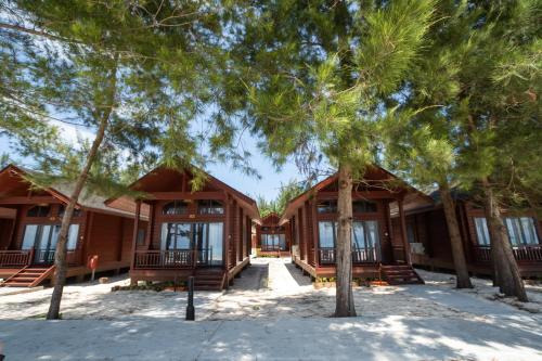 a house with trees in front of it at Sutera at Mantanani Island Resort & Spa in Mantanani Island 