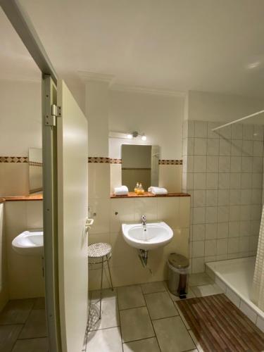 a bathroom with two sinks and a tub and a sink at Big Space-Loft in Hannover