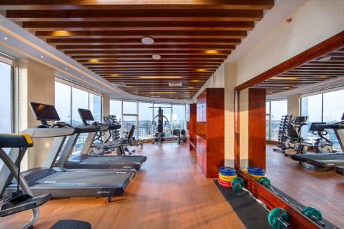 a gym with treadmills and exercise equipment in a building at Grand Palace Hotel & Resort Sylhet in Sylhet