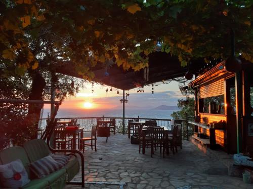 a restaurant with a view of the ocean at sunset at Casa Roja in Faralya