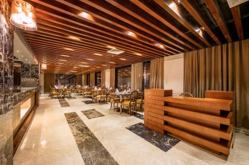 a restaurant with a dining room with tables and chairs at Grand Palace Hotel & Resort Sylhet in Sylhet