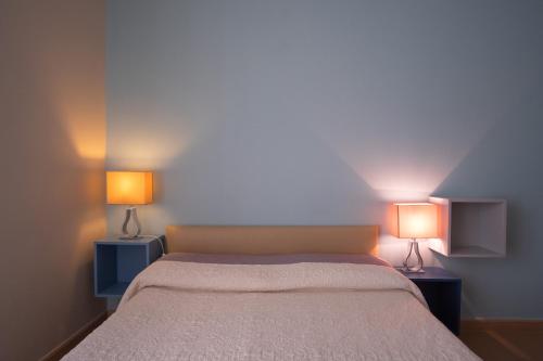 a bedroom with a bed with two lamps on it at Residence Sole Mare Alaxi Hotels in Alassio