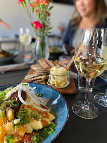 a table with a plate of food and a glass of wine at First Hotel Kokoloko in Visby