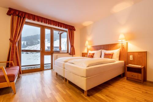 Кровать или кровати в номере Club Hotel am Kreischberg