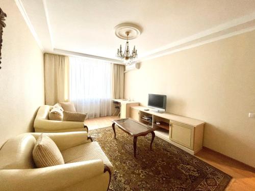 a living room with a couch and a tv at Apartment Mala Zhytomyrska 10 in Kyiv