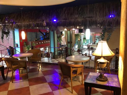a restaurant with tables and chairs in a room at Hotel Club del Sol Acapulco by NG Hoteles in Acapulco