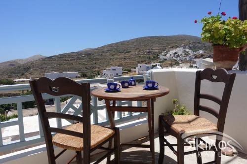 a table and chairs on a balcony with a view at Traditional Apartment In Kastro in Sikinos