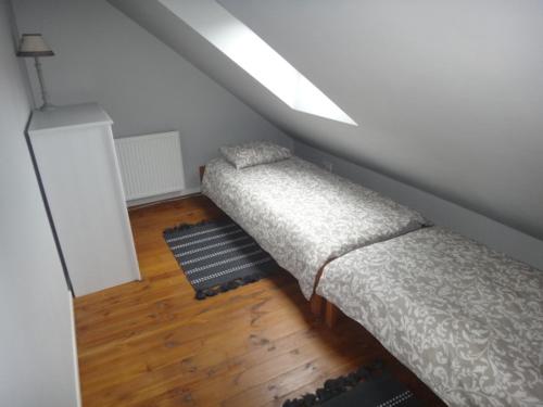 a attic room with two beds and a skylight at Domek Socałówka in Sułkowice