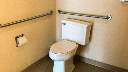 a bathroom with a toilet and a roll of toilet paper at Colonial Inn Ellsworth in Ellsworth