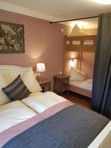 a bedroom with two beds and a bunk bed at Haus Montana in Lermoos