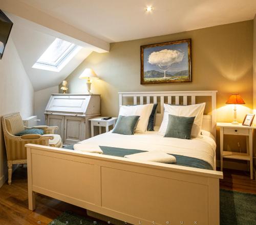 a bedroom with a large bed and a piano at Maison Bleue - Wellness - SPA in Spa