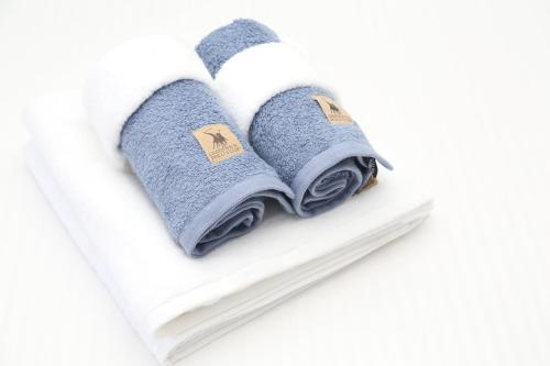 two towels in the shape of a heart on a shelf at Luxury Villa Siniori in Keramoti