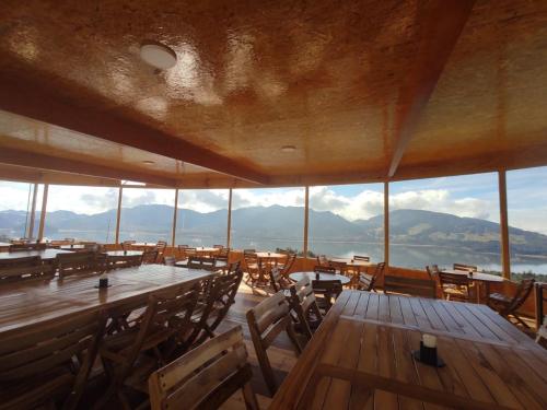 a large room with tables and chairs and mountains at Refugio del Neusa in Cogua