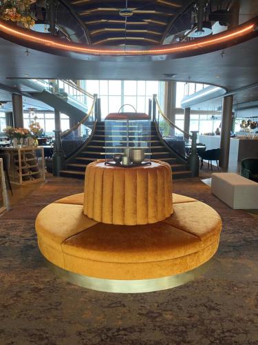 a round table in a room with stairs in the background at Rognan Hotel in Rognan