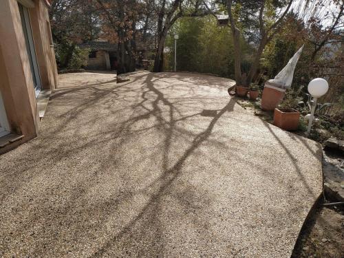 a shadow of a tree on a driveway at La Maison St Gervais in Saint-Gervais