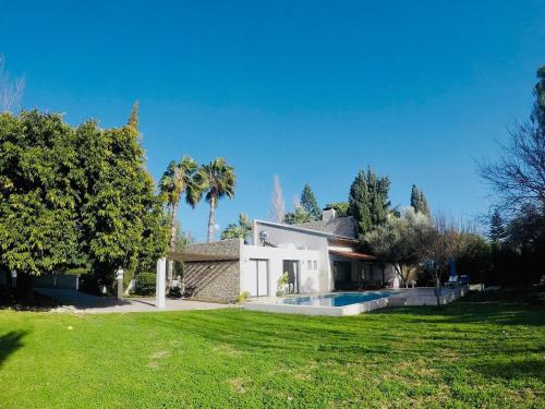 a house with a swimming pool in a yard at The Stone Villa in Pissouri